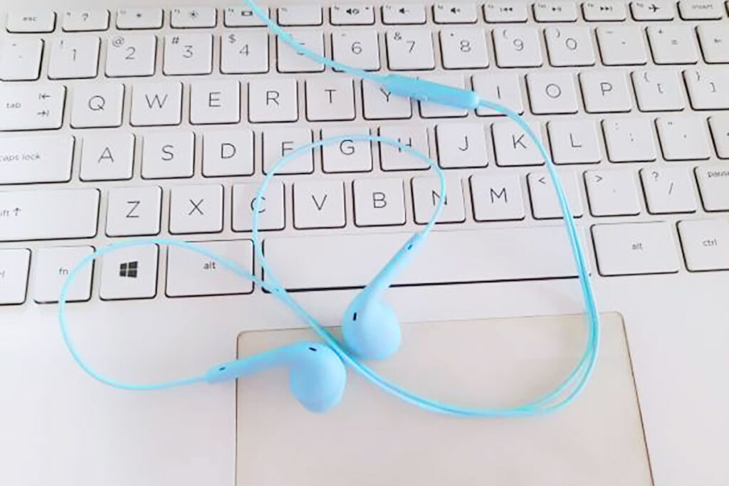 Laptop keyboard with audio earbuds